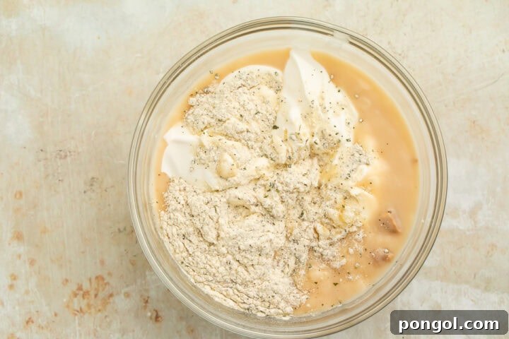 Creamy ranch sauce ingredients being whisked together in glass bowl