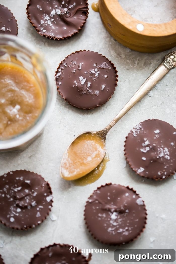Close-up of a Paleo Chocolate Cup with Caramel, showcasing the thick chocolate shell and gooey caramel center. Ideal for vegan and gluten-free diets.