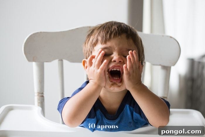 Three paleo chocolate caramel cups arranged on a wooden surface, highlighting their rich chocolate and gooey caramel layers.