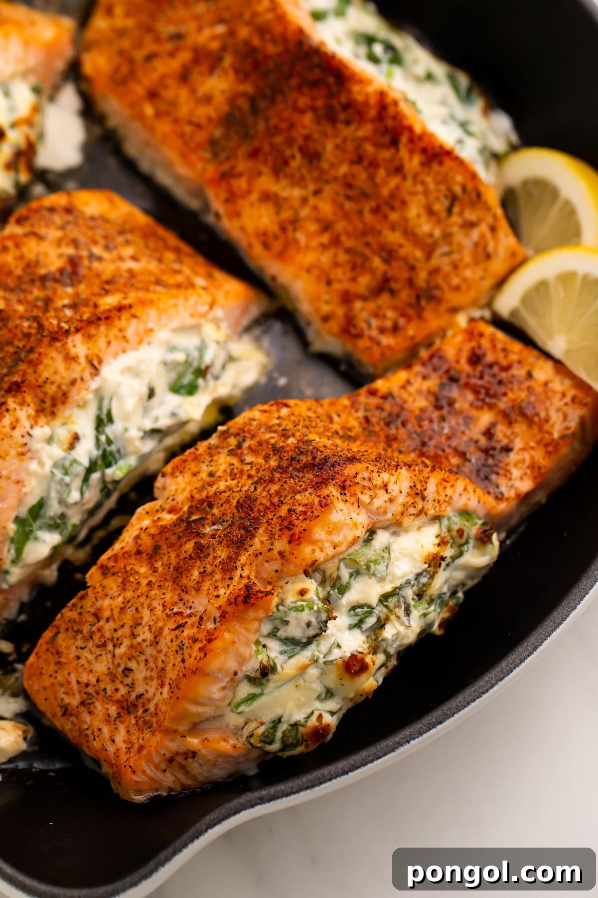 Stuffed Salmon Bake 4 Broiled stuffed salmon fillets with creamy spinach filling in cast iron skillet