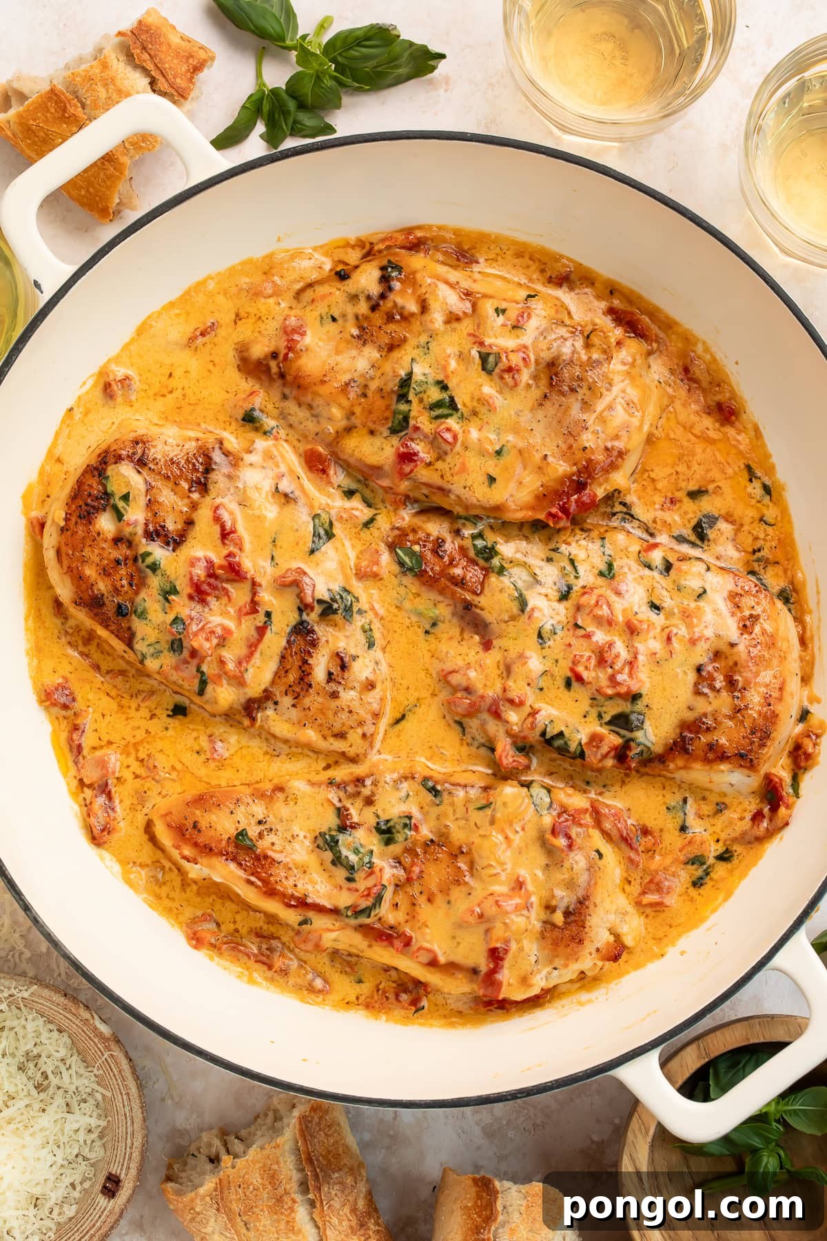 Tender chicken breasts covered in rich cream sauce with herbs and tomatoes