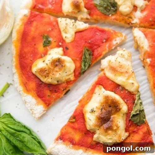 A whole paleo pizza recipe crust with a slice cut out
