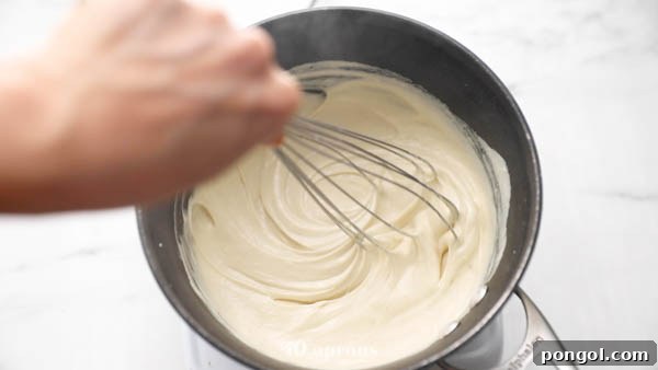 Blending dairy-free mozzarella ingredients and heating them until gooey