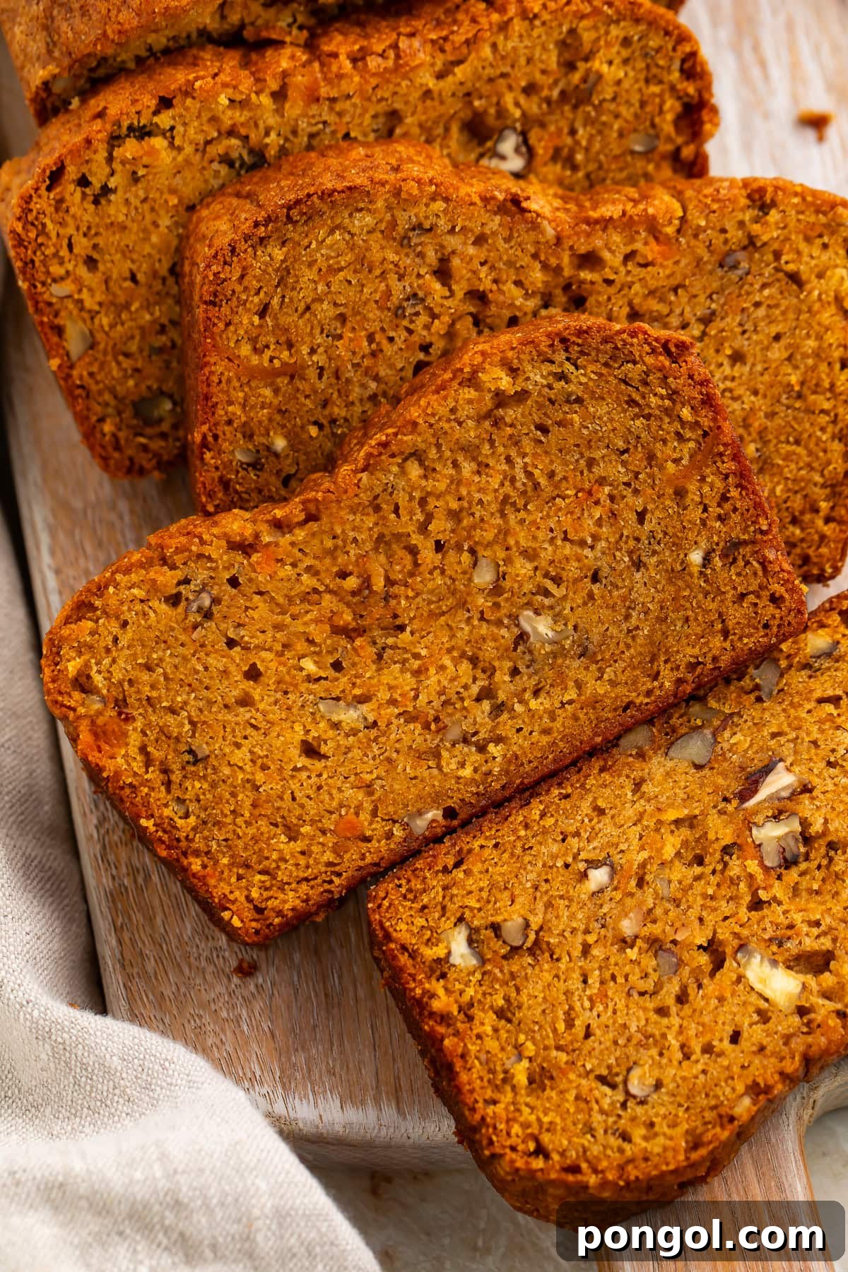 Close-up of sweet potato bread slices showing dense moist texture and pecan pieces