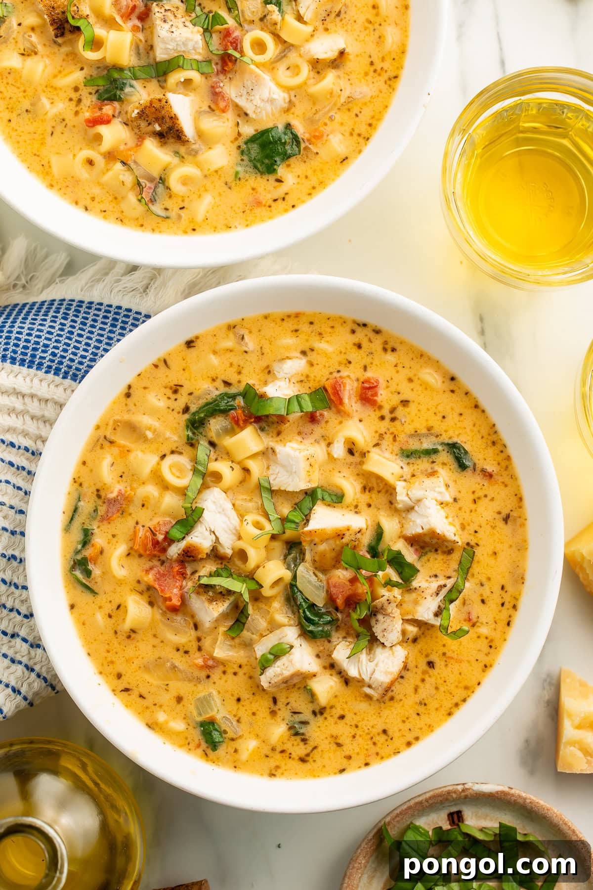 Love-Struck Chicken Soup 3 Close-up of Marry Me Chicken Soup showing creamy texture with visible pasta, seasoned chicken pieces, spinach, sun-dried tomatoes, and fresh basil