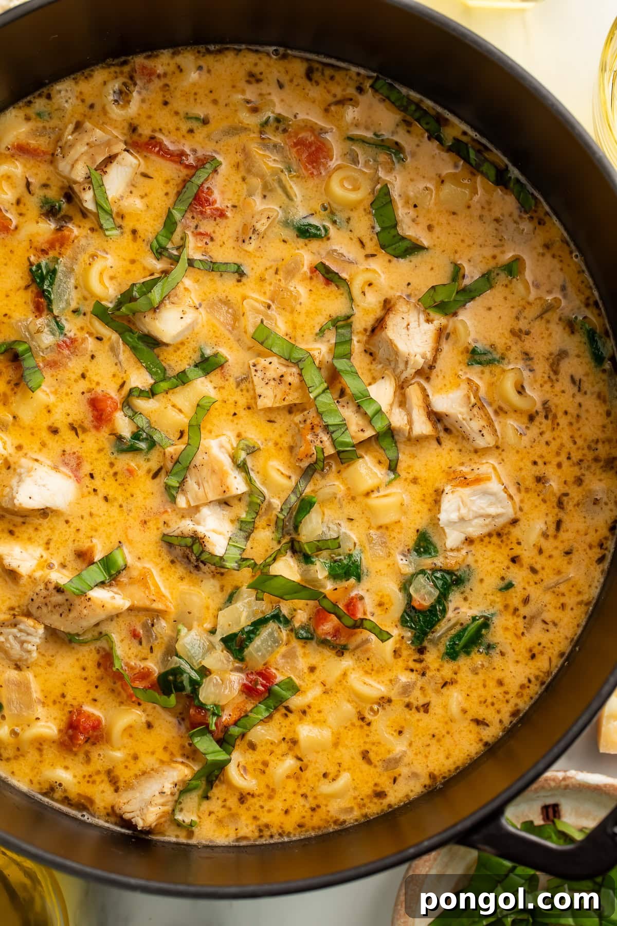 Love-Struck Chicken Soup 4 Marry Me Chicken Soup in a large Dutch oven showing the full one-pot recipe with pasta, chicken, spinach, and creamy Parmesan broth topped with fresh basil