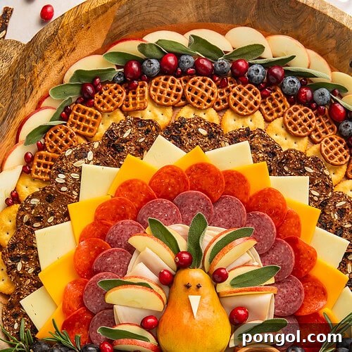 Thanksgiving turkey charcuterie board with pear turkey centerpiece surrounded by meats cheeses fruits and crackers on wooden board