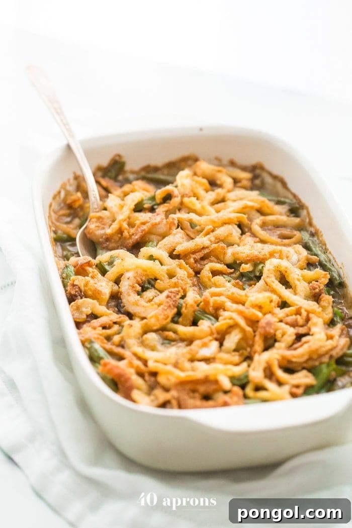 An overhead shot of a freshly baked Whole30 green bean casserole, golden and bubbling, ready to be served. This paleo-friendly dish offers a wholesome twist on the traditional Thanksgiving favorite, without compromising on flavor or texture.
