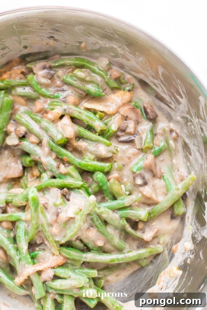 Close-up detail of the crispy fried onions on top of the Whole30 green bean casserole. These homemade, grain-free onion straws add essential texture and flavor to the paleo casserole, making it a standout dish.