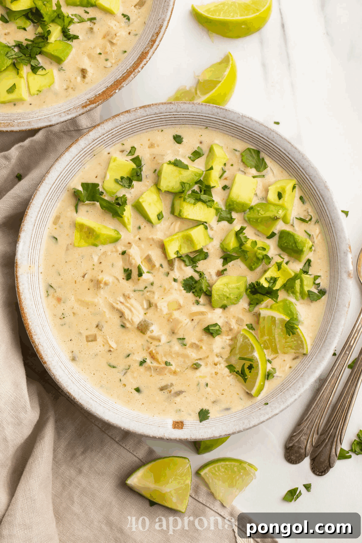 Whole30 White Chicken Chili topped with fresh cilantro and avocado