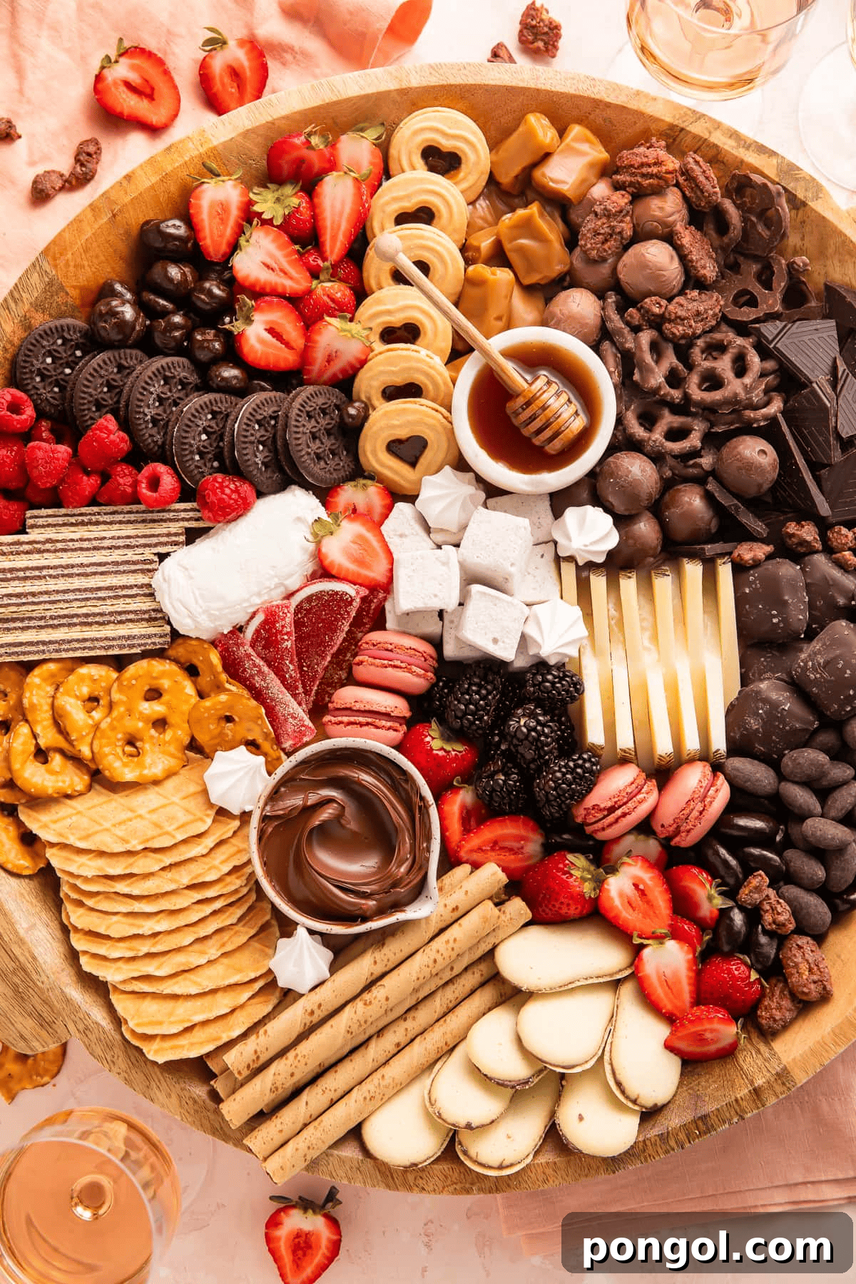 Dessert Charcuterie Board loaded with chocolates, cookies, berries, and cheese