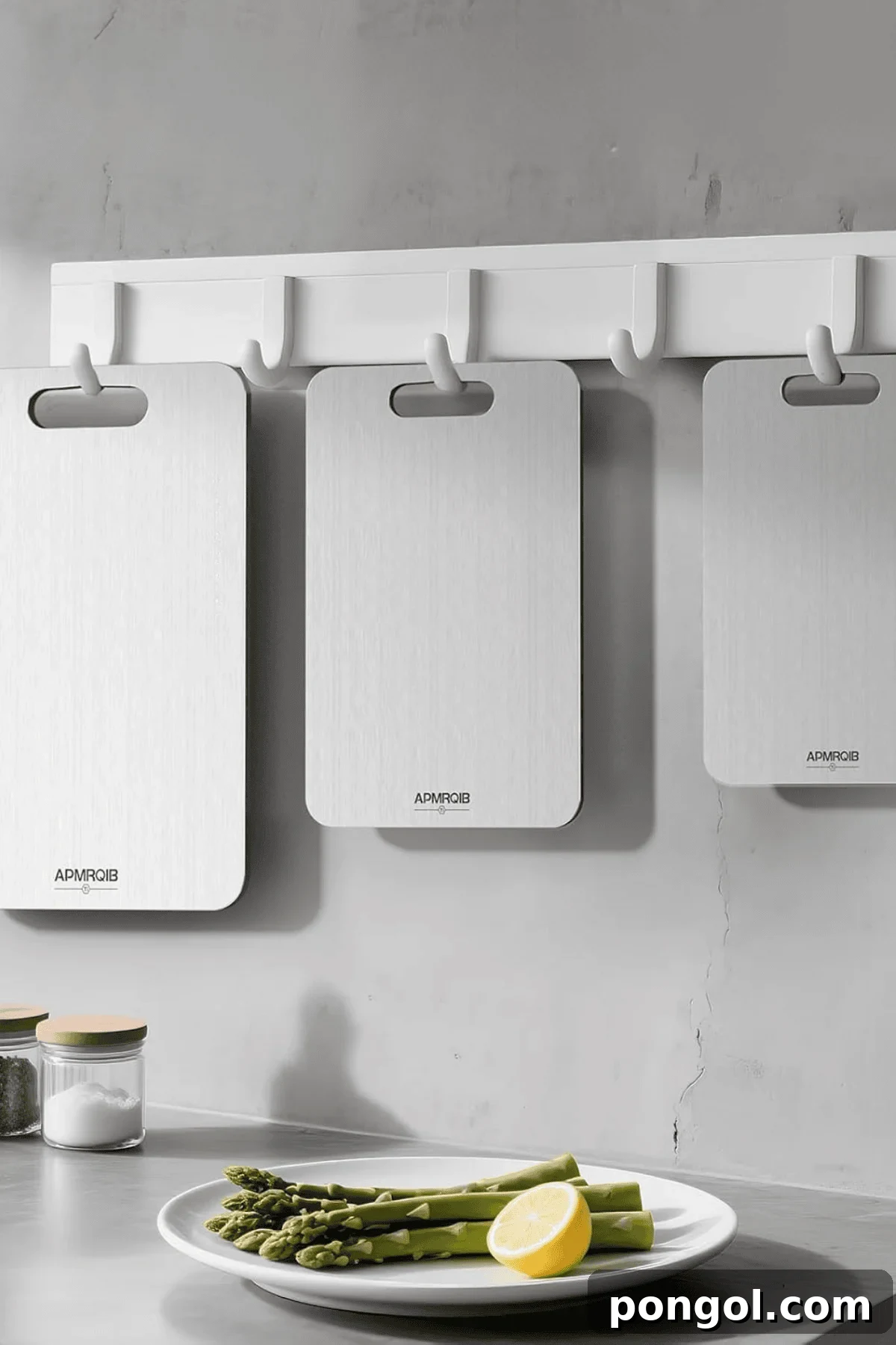 Unveiling 2026s Best Kitchen Innovations and Home Upgrades You Need to See 18 Three white titanium cutting boards hanging on wall hooks above asparagus plate