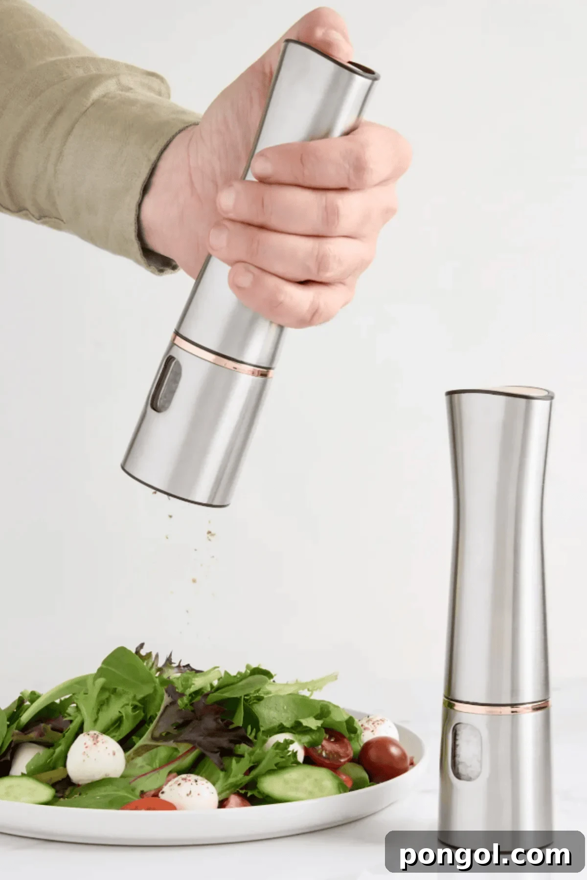 Unveiling 2026s Best Kitchen Innovations and Home Upgrades You Need to See 20 Hand holding Quince stainless steel electric pepper mill grinding seasoning over fresh salad