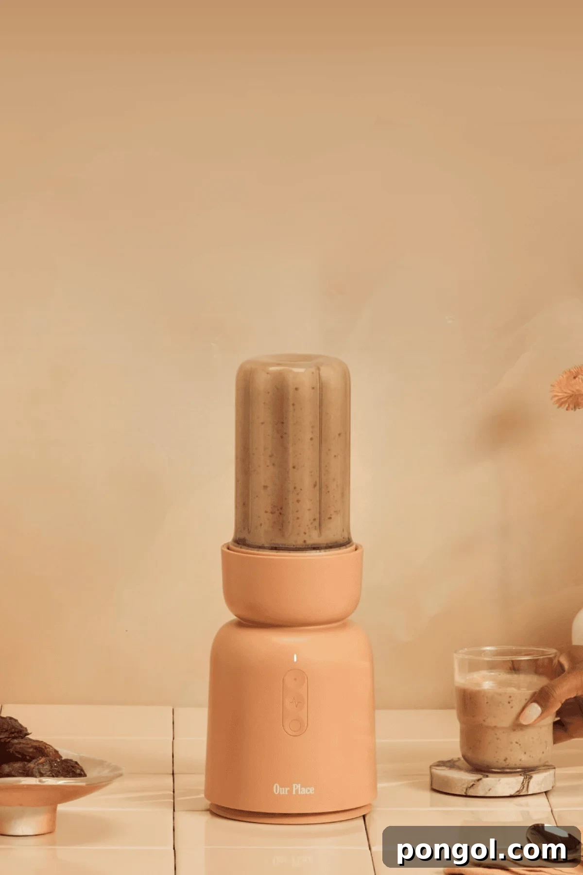 Unveiling 2026s Best Kitchen Innovations and Home Upgrades You Need to See 5 Our Place personal blender in coral color blending smoothie on countertop