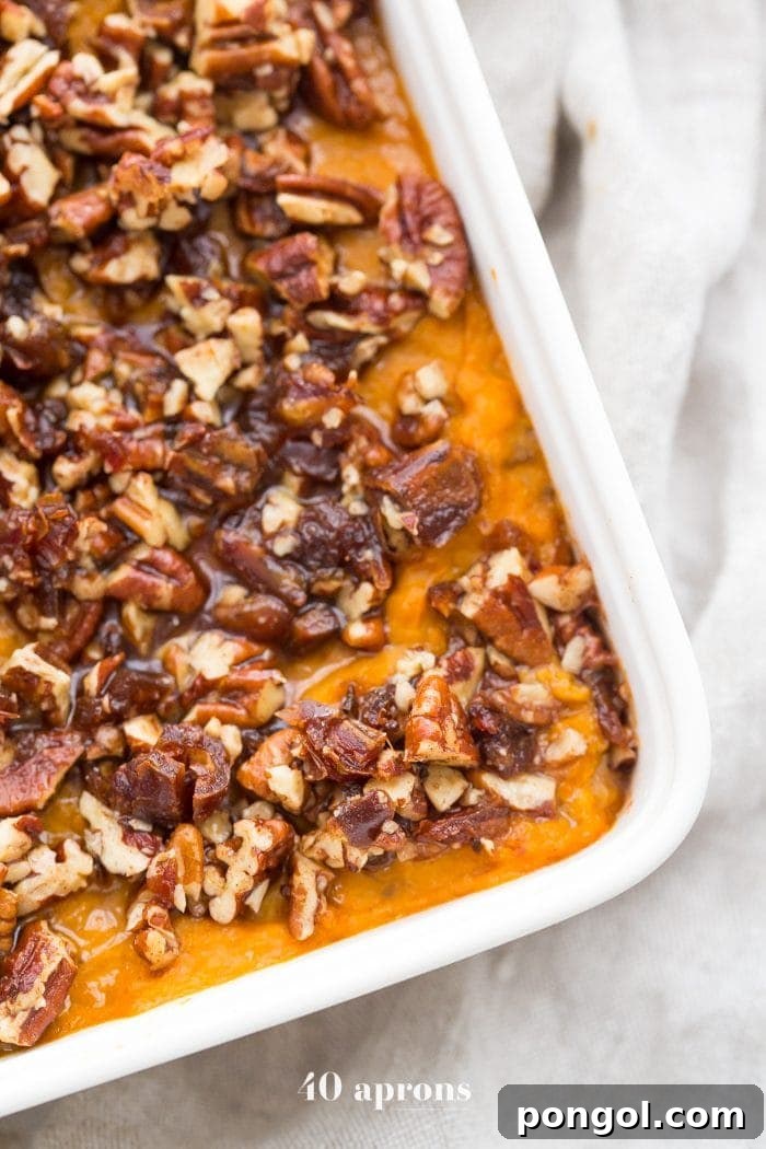 Delicious Whole30 sweet potato casserole with a generous pecan-date topping, ready for your Thanksgiving table.