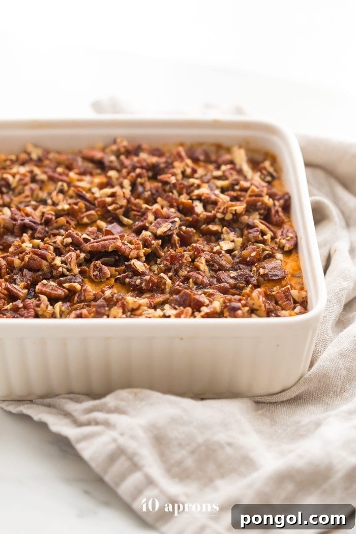 Close-up of the Whole30 sweet potato casserole, showcasing the creamy texture and rich pecan-date topping.