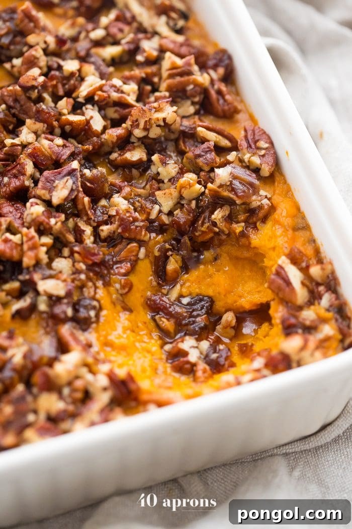 The Whole30 sweet potato casserole ready for the oven, topped with the crumbly pecan-date mixture.