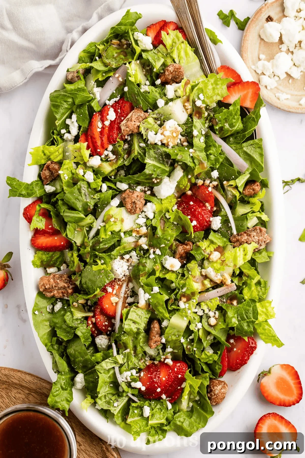 Fresh strawberry and goat cheese salad with mixed greens, candied nuts, and a light vinaigrette, perfect for a romantic meal