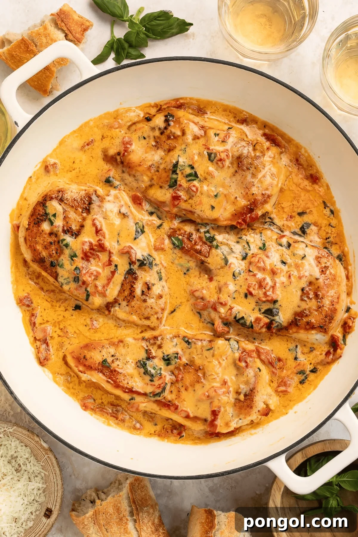 Creamy Marry Me Chicken dish with sun-dried tomatoes and fresh basil, served in a skillet