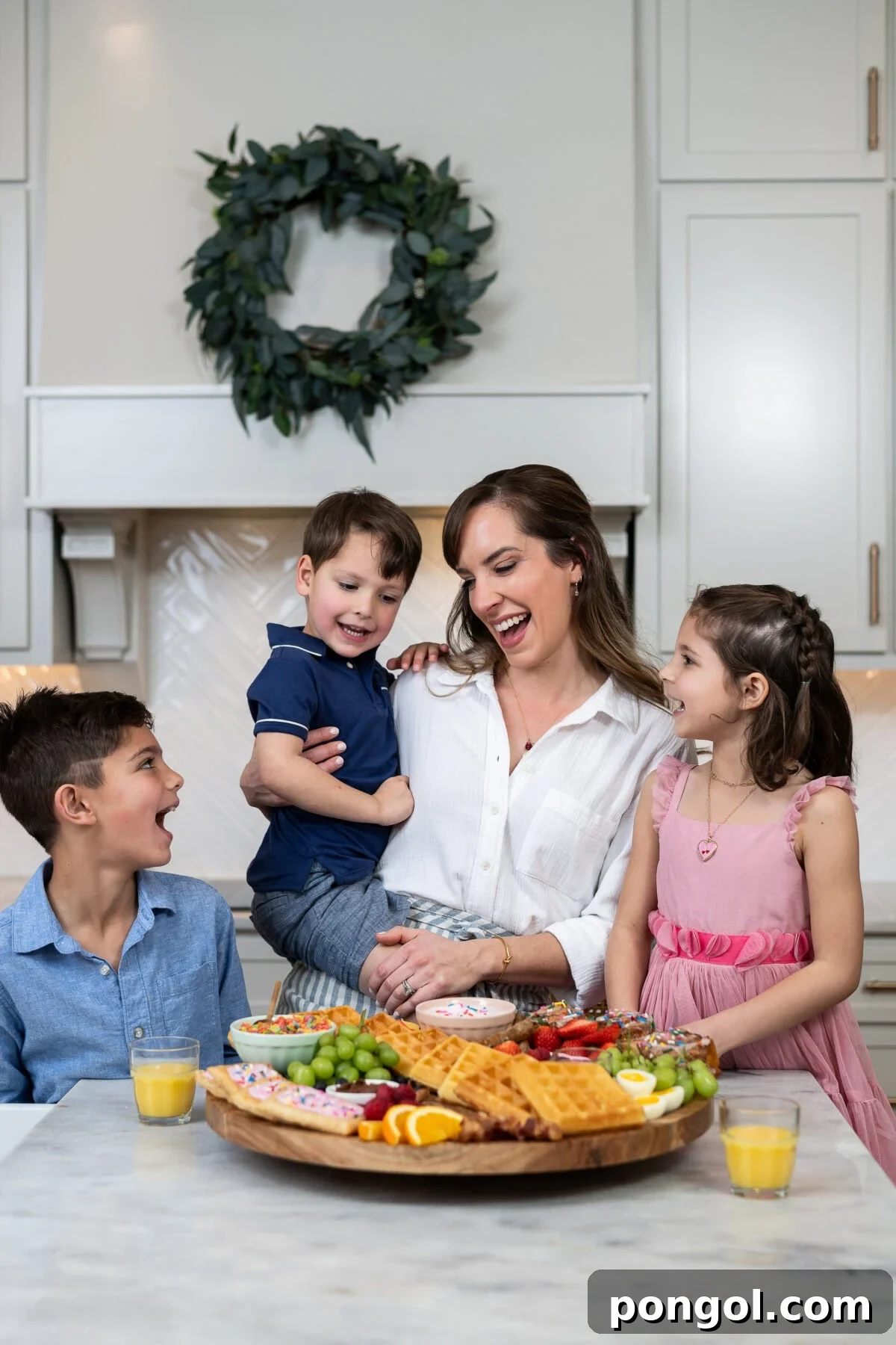 Little Loves' Valentine's Day Feast 2 A young child's hand holding a tiny spoon with Goldfish crackers and cream cheese, part of a fancy kids' Valentine's dinner menu