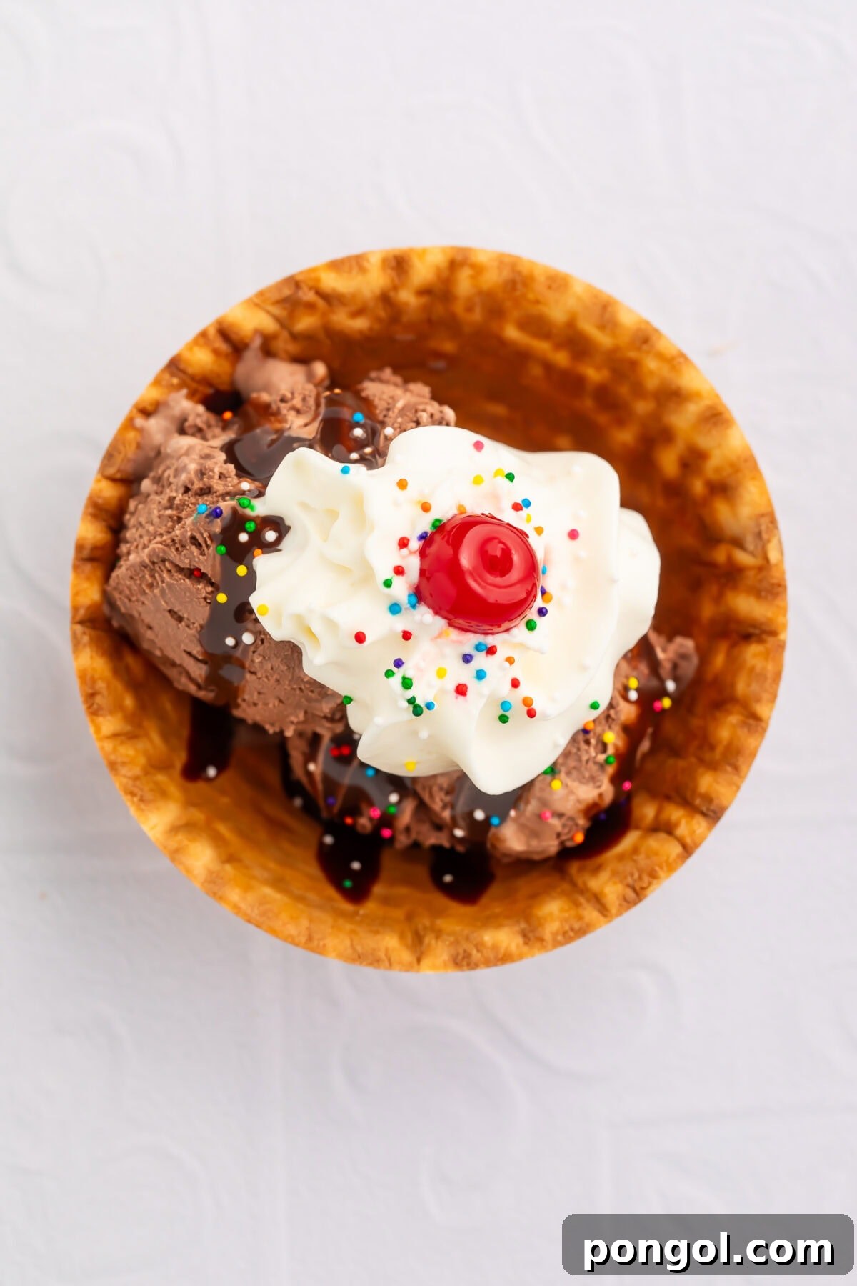 Little Loves' Valentine's Day Feast 8 Decadent sweetheart ice cream sundae in a waffle bowl, topped with chocolate syrup, whipped cream, sprinkles, and a maraschino cherry