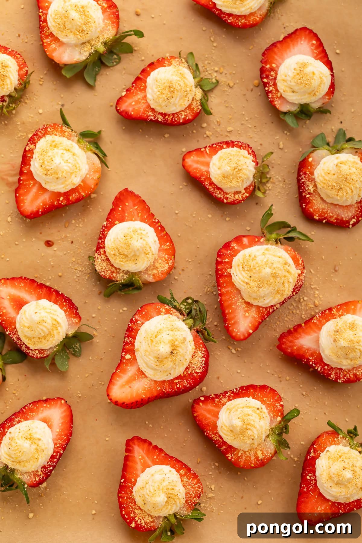 Strawberry Deviled Delights 3 Overhead view of deviled strawberries with cream cheese filling arranged on brown parchment paper