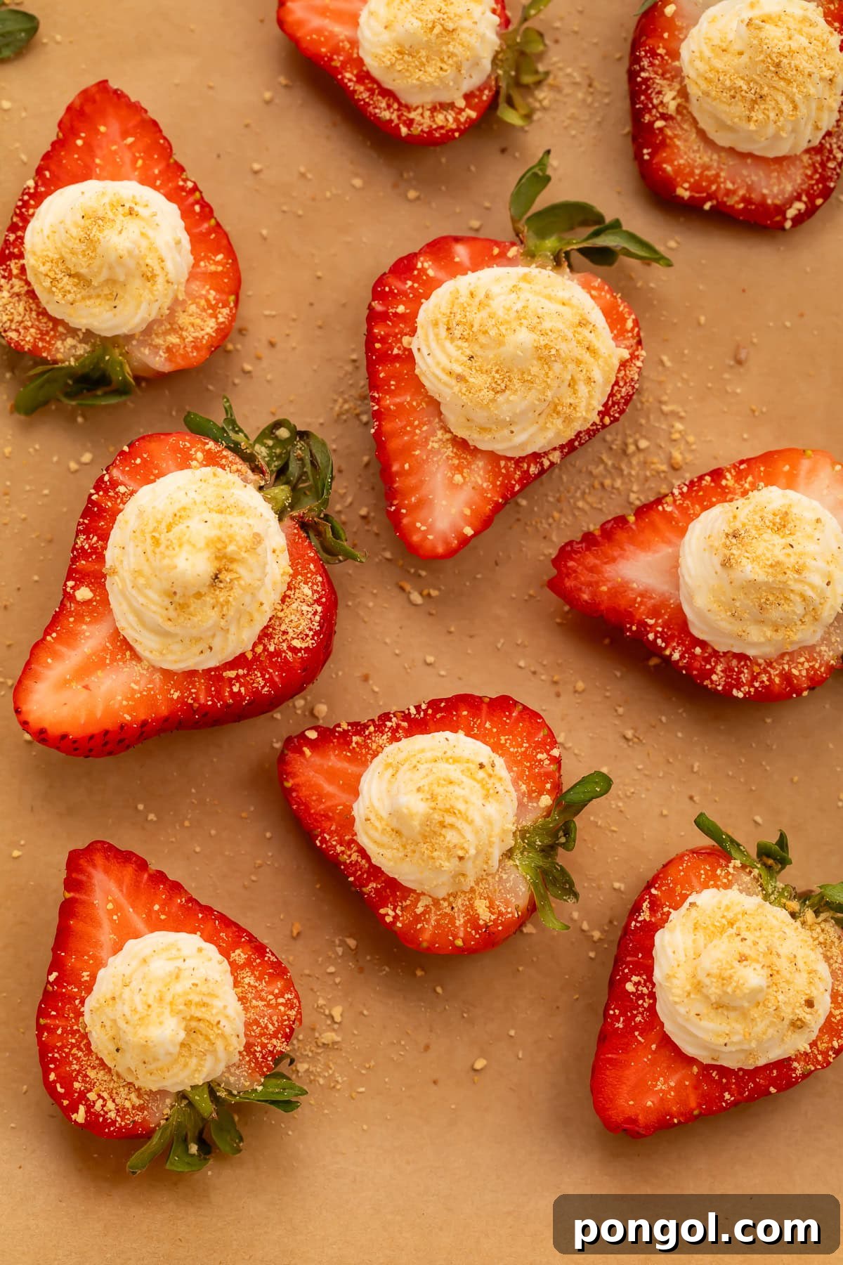 Strawberry Deviled Delights 4 Deviled strawberries with whipped cream cheese filling and graham cracker crumbs on parchment paper
