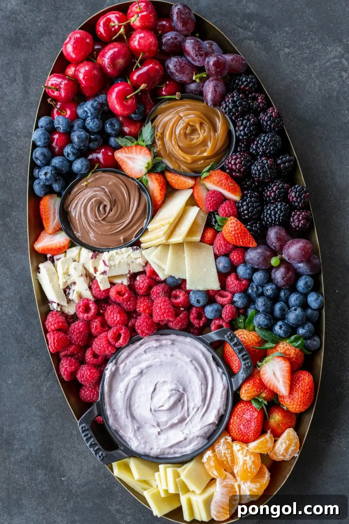 Easter Feasts Gifts and Fun Your Complete Celebration Guide 5 A vibrant and abundant fruit charcuterie board, featuring a colorful array of fresh fruits, cheeses, and dips, ideal for a spring brunch.