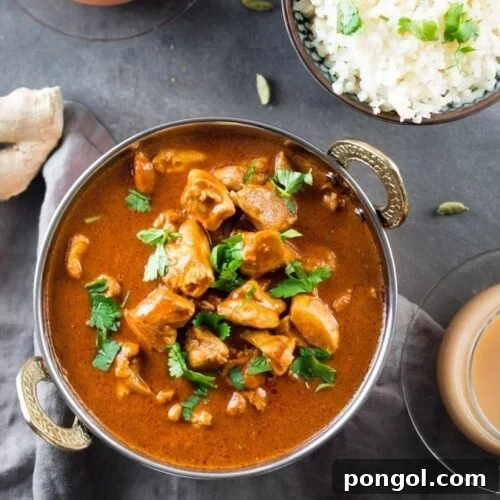 Indian butter chicken in a bowl with cauliflower rice and chai tea