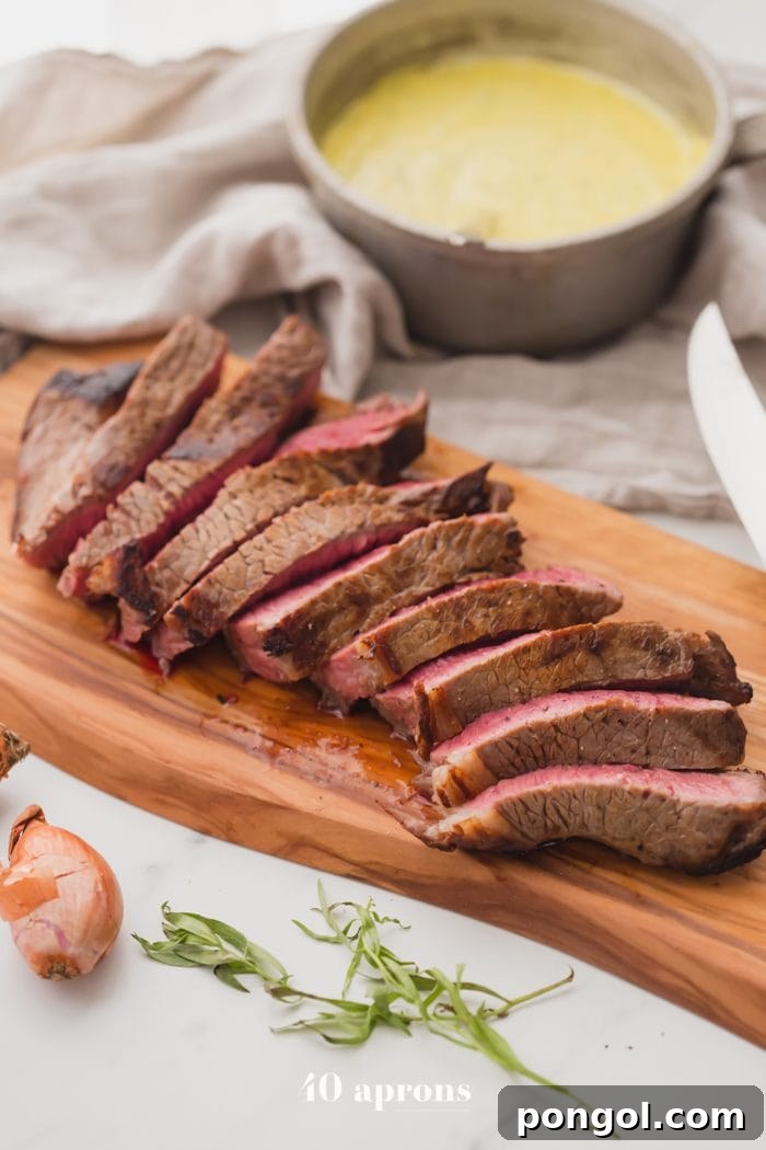 Medium-rare Whole30 steak with Whole30 béarnaise sauce in a dish