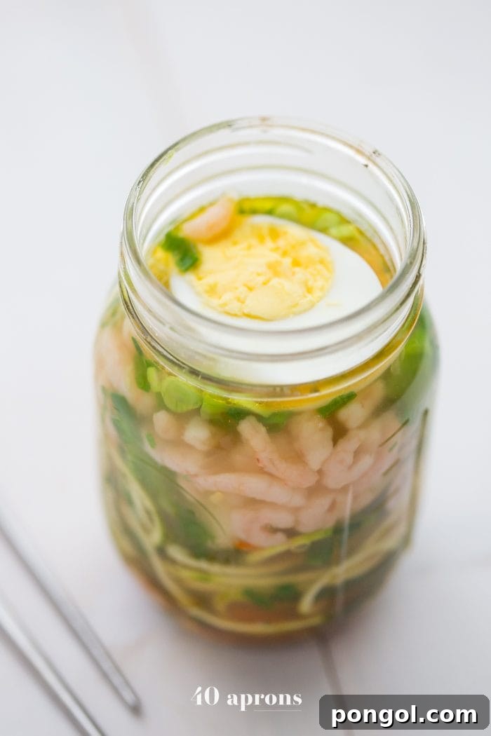 Whole30 Paleo Zoodle Cups 5 Whole30 snack cup zoodles: zucchini noodles with vegetables and shrimp in a mason jar, showcasing the vibrant and fresh ingredients.