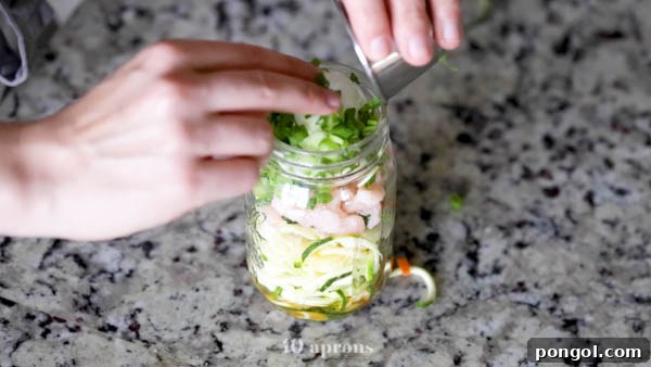 Whole30 Paleo Zoodle Cups 7 Layer zoodles, veggies, shrimp, egg, and scallions in a mason jar for convenient Whole30 cup zoodles.