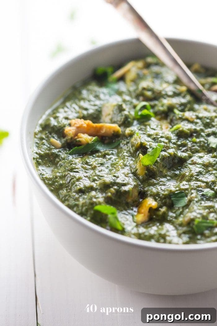 Nourishing Indian Saag Chicken Whole30 Paleo 2 Whole30 Indian saag chicken in a white bowl, garnished with fresh cilantro, ready to be served