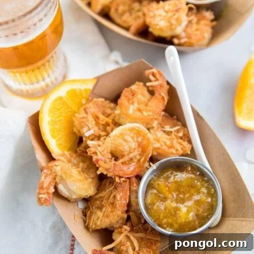 Tangy Orange Coconut Shrimp for Whole30 and Paleo 6 Whole30 coconut shrimp with orange sauce in a container