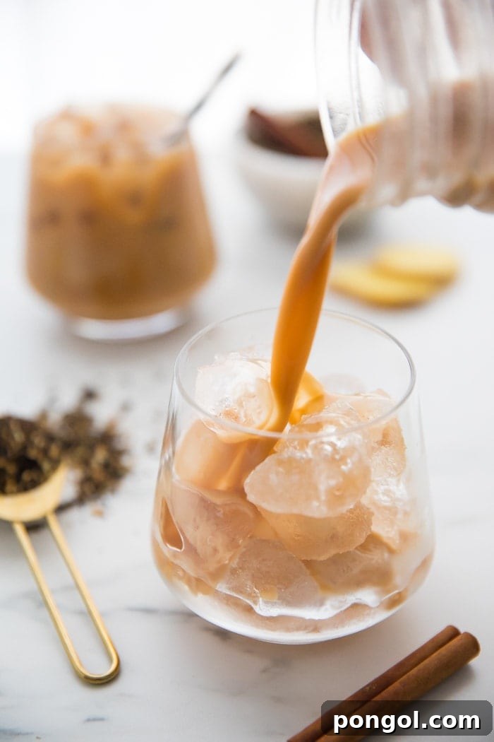 Iced Dirty Chai, Elevated: Vegan, Paleo, Sugar-Free Goodness 4 Pouring vegan chai latte into a glass.