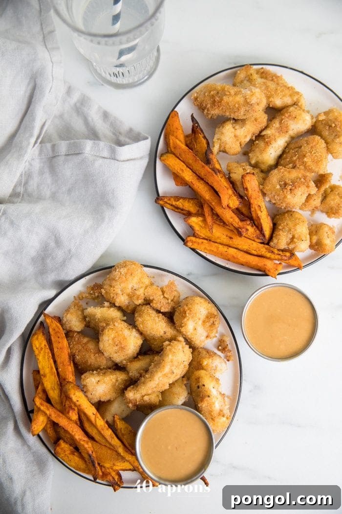 Paleo Whole30 chicken nuggets recipe Chick-Fil-A style on a plate with dipping sauce and sweet potato fries