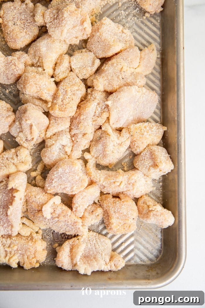 Whole30 chicken nuggets recipe breaded on a baking sheet