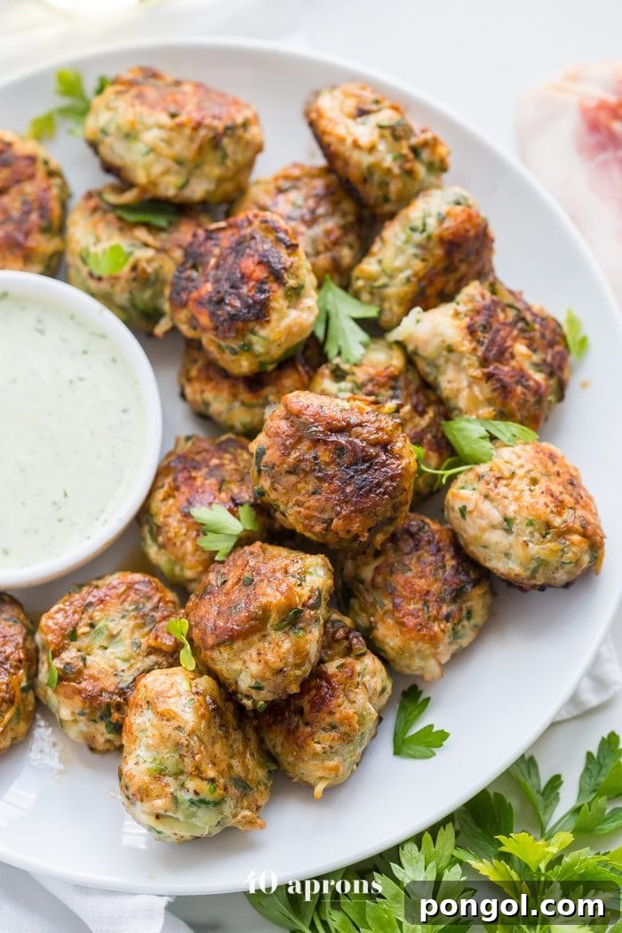Close-up of a single Whole30 Chicken Bacon Ranch Popper, showing the perfectly browned exterior and crispy bacon texture, ready to be enjoyed.