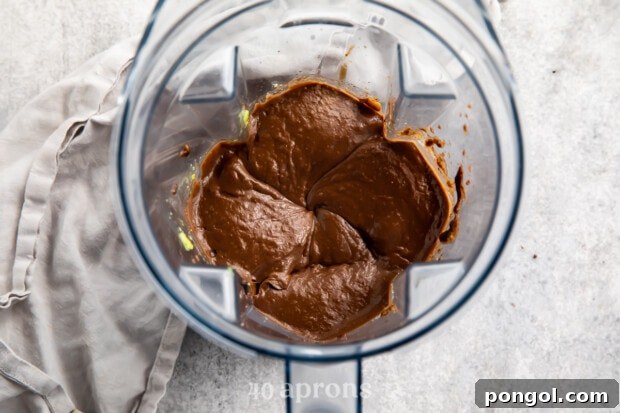 Overhead view of avocado chocolate mousse in a blender.