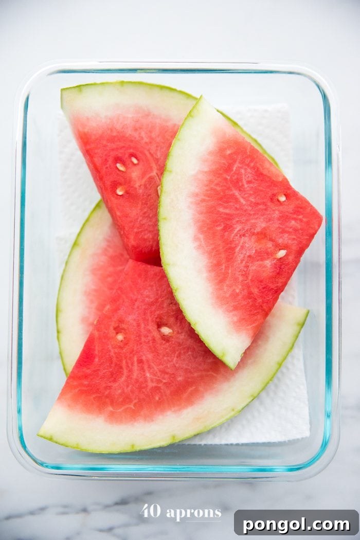 Assorted fresh fruits, including slices of watermelon, arranged beautifully for a healthy and refreshing Whole30 picnic dessert.
