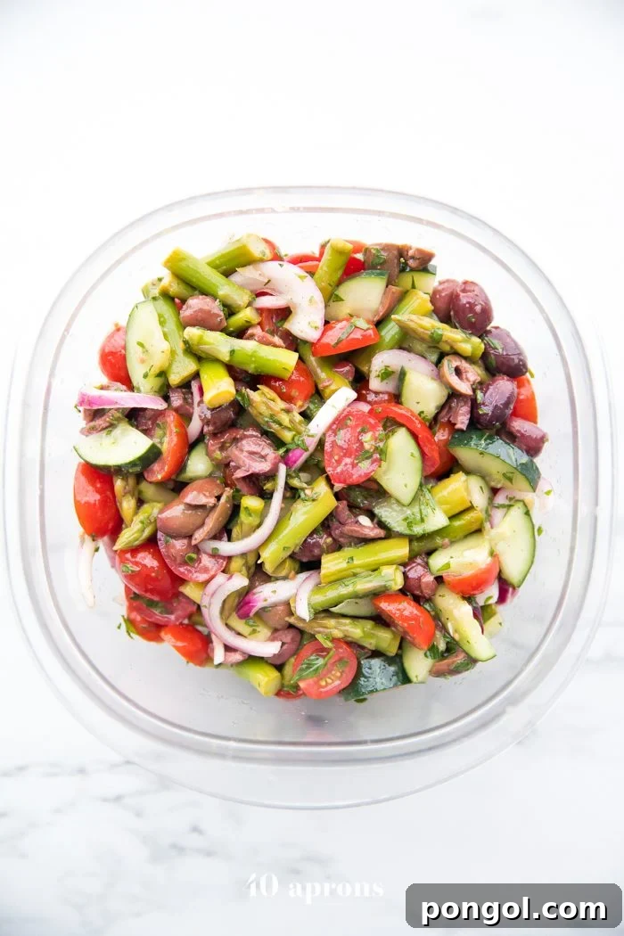 A vibrant Greek Veggie Salad in a bowl, perfect for a healthy and refreshing Whole30 picnic side dish.