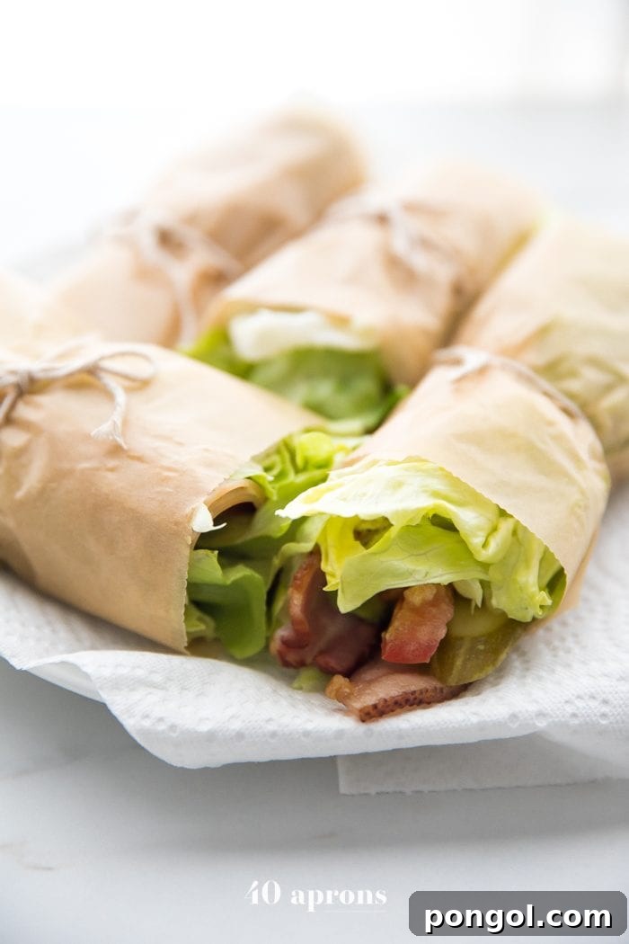 Delicious Ranch Club Turkey Lettuce Wraps, packed with fresh ingredients, laid out on a board for a healthy Whole30 picnic.