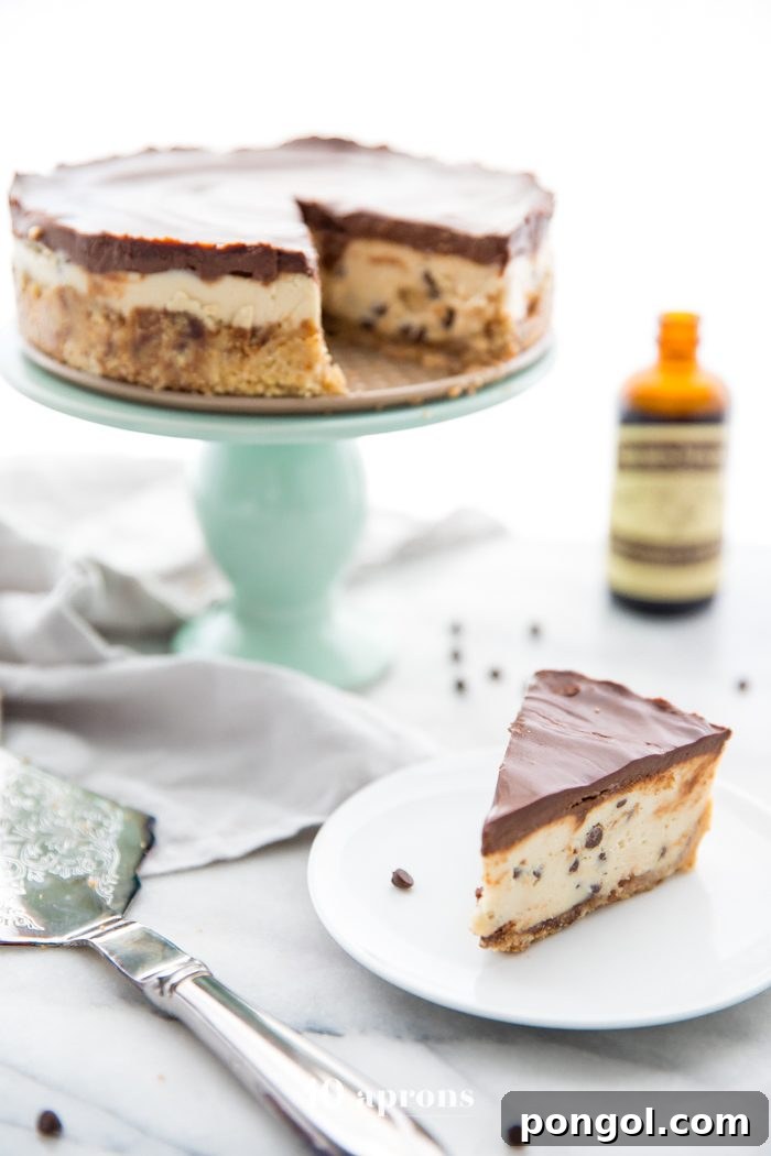 Slice of vegan no bake cookie dough cheesecake on a white plate with a fork.