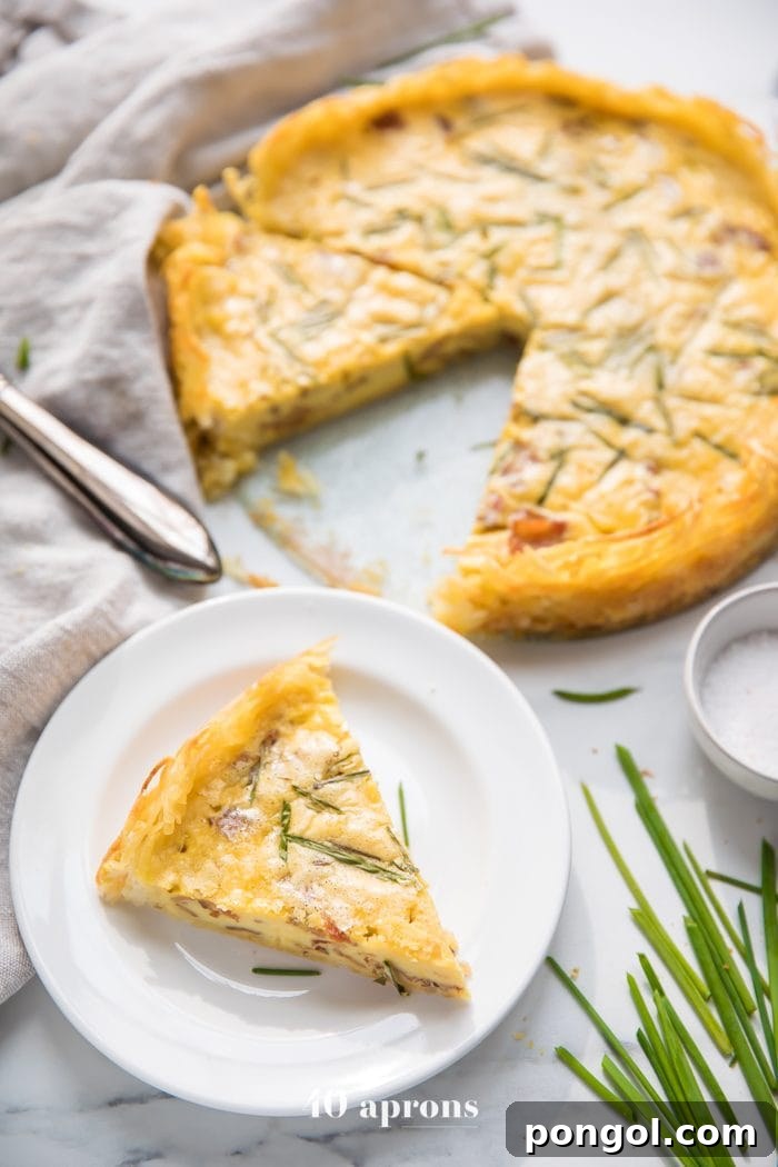Whole30 quiche lorraine with hash brown crust slice with whole quiche in background