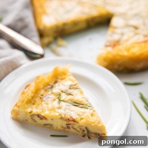 Whole30 quiche lorraine with hash brown crust slice with whole quiche in background