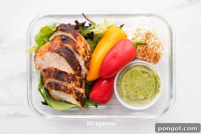 Single meal prep container with healthy Mexican chicken, eggs, and mini peppers, ready to eat