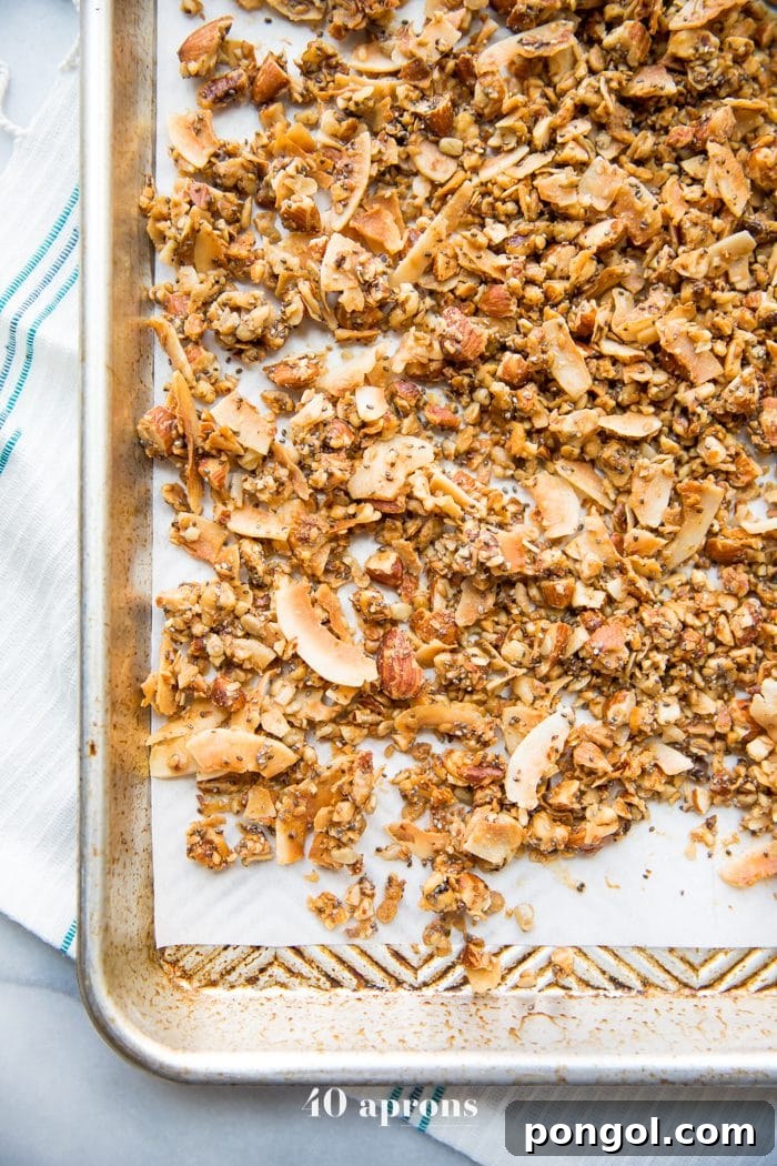 A baking sheet of the crunchy paleo granola recipe spread out over parchment paper