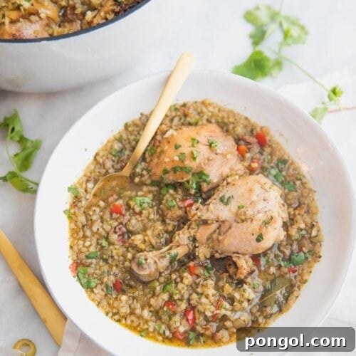 Healthy Spanish chicken and cauliflower rice stew in a bowl with a pot of the stew next to it