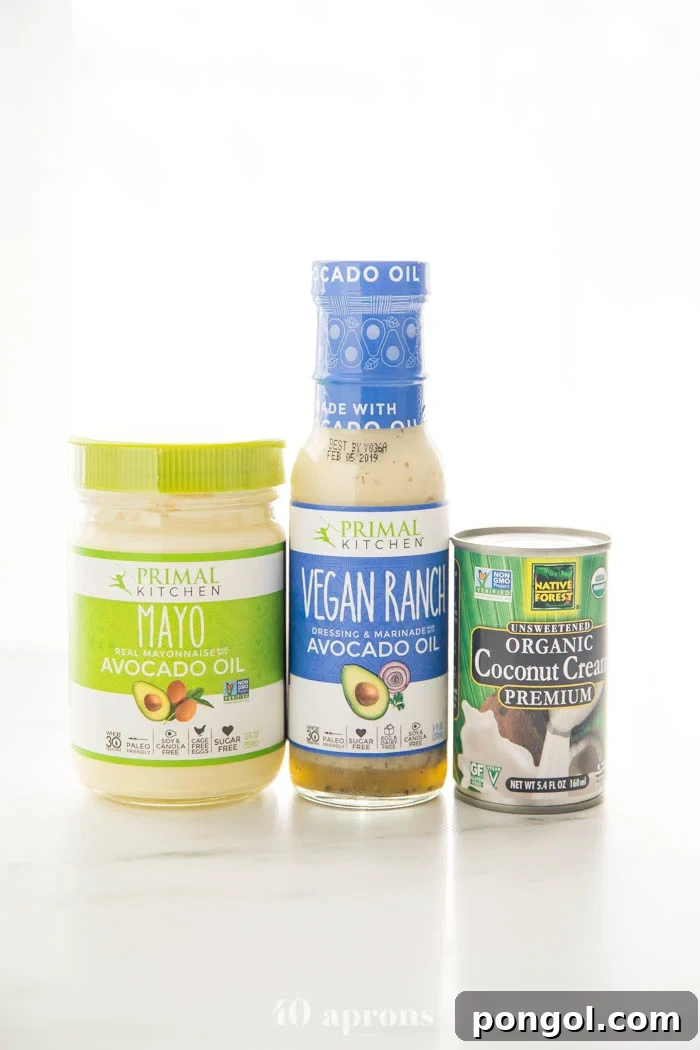 Three key Whole30 and Paleo ingredients from Thrive Market: Primal Kitchen Avocado Oil Mayo, Primal Kitchen Vegan Ranch, and Native Forest Organic Coconut Cream, essential for a compliant buffalo chicken casserole.
