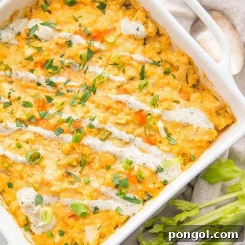 Paleo Buffalo Chicken Casserole in a white dish with celery stalks to the side